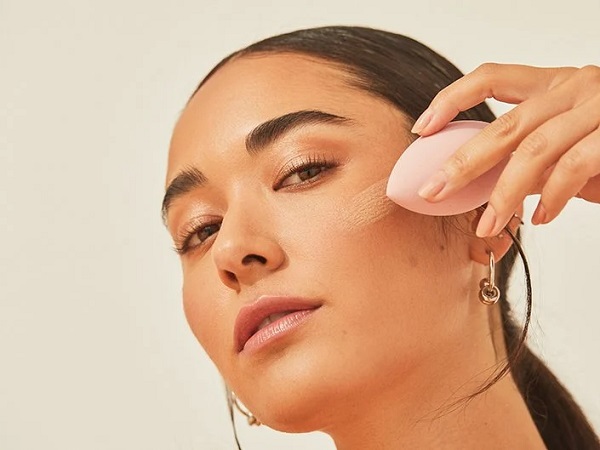 Applying foundation with makeup sponge